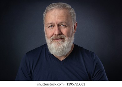 Happy 60 Year Old Man With Gray Beard Posing In The Studio