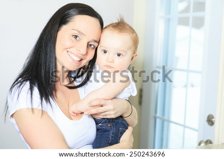 Happy 8 month old baby boy with mother