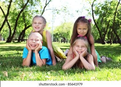 Happy active children playing in the summer park