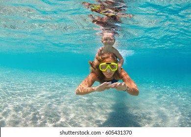 Happy Active Family - Mother, Baby Son Snorkel And Dive Together Underwater In Sea Pool. Healthy People Lifestyle, Water Sport Outdoor Adventure, Swimming Lesson On Summer Beach Vacation With Child