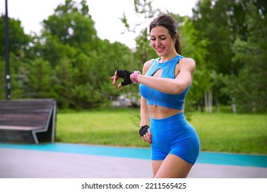 happy active girl runner, young fit woman is jogging, running outdoors, checking her smart watches at wrist, looking at smartwatches, tracking pulse, measuring heartbeat, heart rate after workout - Powered by Shutterstock