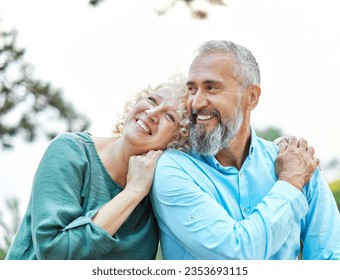 Happy active mid middle aged adult mature couple having fun talking and hugging in park outdoors - Powered by Shutterstock