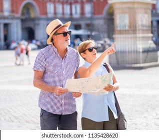 Happy Active Retired Tourist Couple Searching For Their Location In Plaza Mayor Madrid In Travel Around Europe Holidays Retirement Concept.