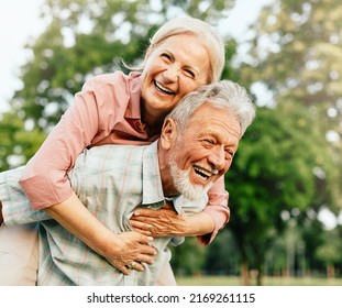 Happy active senior couple having fun outdoors. Portrait of an elderly couple together - Powered by Shutterstock