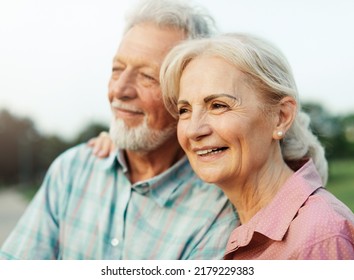 Happy Active Senior Couple Having Fun Outdoors. Portrait Of An Elderly Couple Together