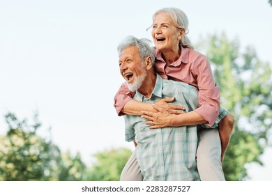 Happy active senior couple having fun outdoors. Portrait of an elderly couple together - Shutterstock ID 2283287527