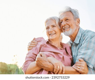 Happy active senior couple having fun talking and hugging in park outdoors - Powered by Shutterstock