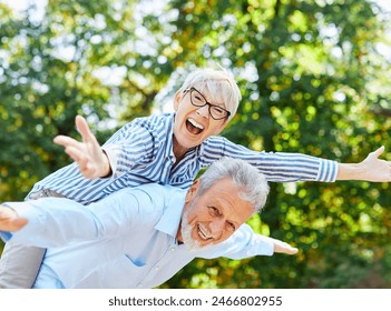 Happy active senior couple having fun outdoors. Portrait of an elderly couple together - Powered by Shutterstock