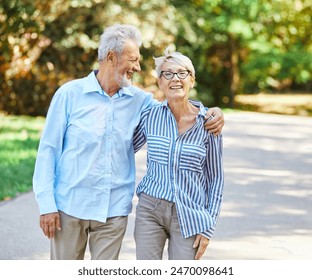 Happy active senior couple having fun talking holding hands and bonding in park outdoors - Powered by Shutterstock