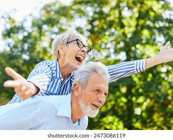 Happy active senior couple having fun outdoors. Portrait of an elderly couple together - Powered by Shutterstock