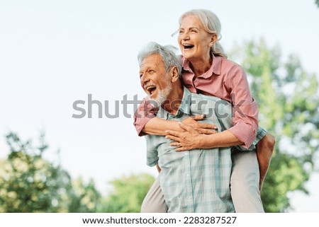 Happy active senior couple having fun outdoors. Portrait of an elderly couple together