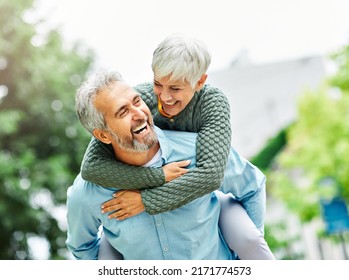 Happy active senior couple outdoors - Shutterstock ID 2171774573