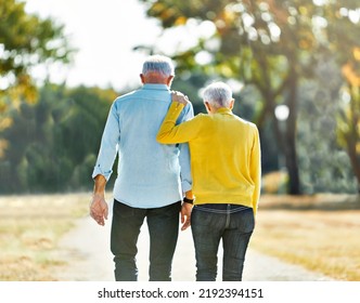 Happy Active Senior Couple Walking And Holding Hands Outdoors