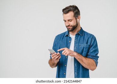 Happy active young student male man freelancer listening to the music in earphones, choosing sound track, podcast radio station playlist in music application - Powered by Shutterstock