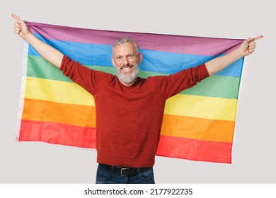 Happy Activist Caucasian Mature Middle-aged Man Holding Rainbow LGBT Flag For Showing Freedom In Love, Supporting Sexual Minorities Community And Equal Rights For Gays And Lesbians