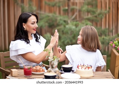 Happy Adorable Girl With Mom Celebrate With Birthday Cake In Cafe Terrace. 10 Year Old Celebrate Birthday.