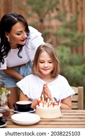 Happy Adorable Girl With Mom Celebrate With Birthday Cake In Cafe Terrace. 10 Year Old Celebrate Birthday