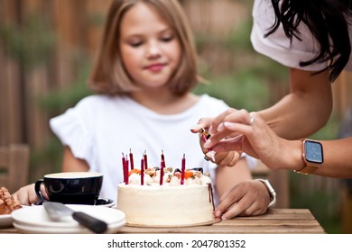 Happy Adorable Girl With Mom Celebrate With Birthday Cake In Cafe Terrace. 10 Year Old Celebrate Birthday.