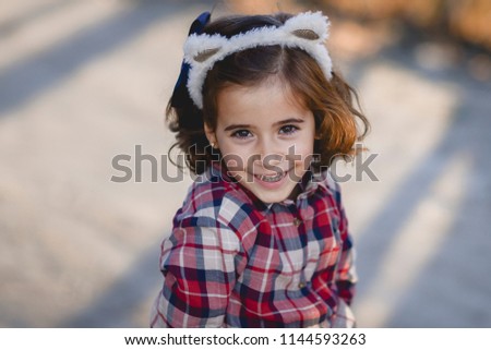 Happy adorable little girl smiling outdoors.