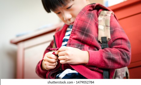 Happy And Adorable Little Preschool Asian Boy Concentrate On Learning To Zip And Unzip His Jacket, Get Ready To School. Montessori, Daily Routine, Self Care, Practical Life Skills, Child Development