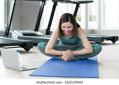 Happy Adult Beautiful Woman Sport Wear Stretching With Computer Note Book At Home Fitness	