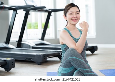 Happy Adult Beautiful Woman Sport Wear Stretching With Computer Note Book At Home Fitness	