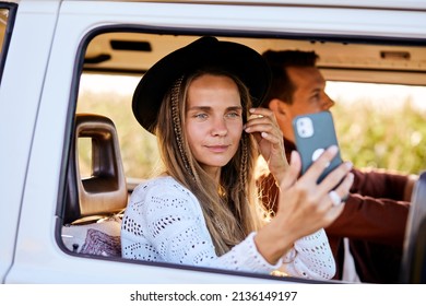 Happy adult beautiful young woman inside an old vintage trendy yellow van enjoying the trip and travel lifestyle looking at mobile phone with internet connection. people lifestyle, alternative people - Powered by Shutterstock