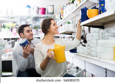 Happy Adult Couple Buying Ceramic Ware In The Shop