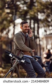 Happy Adult Man, Spending The Day Outside, Leaned On The Bicycle, Talking To Someone Over The Phone.