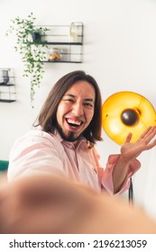 A Happy Adult Person Who Is Smiling And Looking In The Lens Of Camera In The Room - Hold By Hand. High Quality Photo