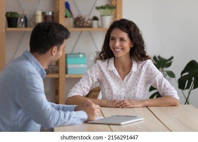 Happy adult students, interns discussing class project at table, chatting, laughing, Corporate coworkers, recruit agent, HR manager and hob candidate meeting in office for interview, talking