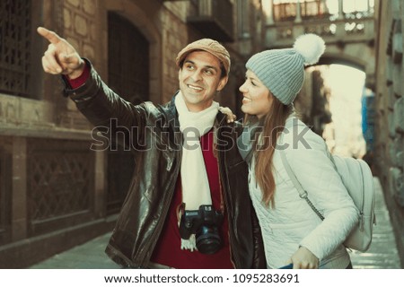 Similar – couple taking selfie in the street