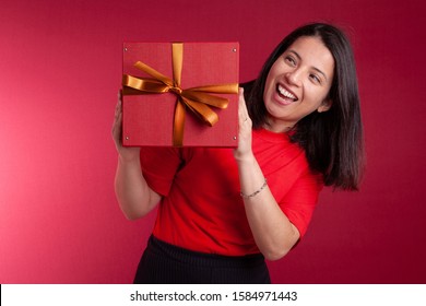 Happy Adult Woman Winning A Gift With Golden Bow