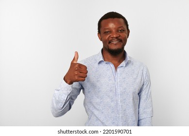 Happy African American Black Man With Thumbs Up Like Gesture In Casual Bright Shirt Isolated On White Background. Smiling Adult Black Guy Portrait With Thumbs Up, Candid Excited Male Emotion