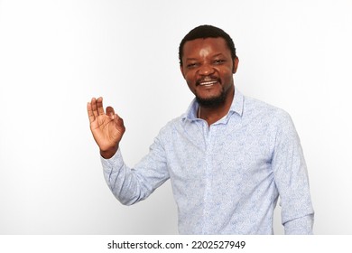 Happy African American Black Man With OK Gesture In Casual Bright Shirt Isolated On White Background. Smiling Adult Black Guy Portrait With Okay Gesture, Candid Excited Male Emotion