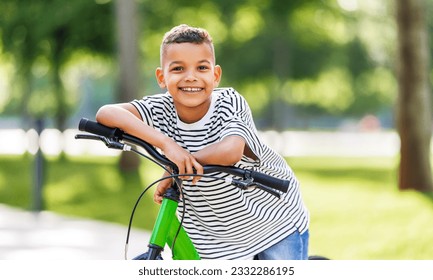 happy african american boy riding bike in park in summer
 - Powered by Shutterstock