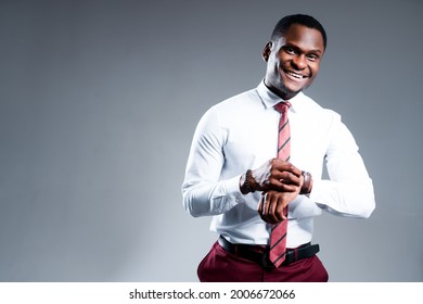 Happy african american businessman in shirt touching watch on wrist and going to work - Powered by Shutterstock