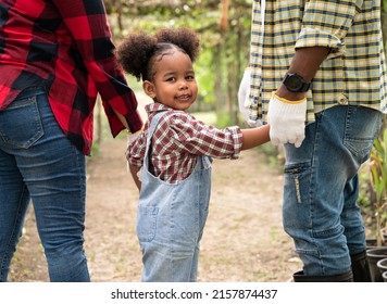 Happy African American Child Girl With Holding Hand Family At Farm