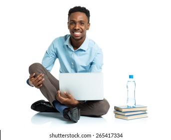 Happy African American College Student With Laptop, Books And Bottle Of Water Sitting On White Background