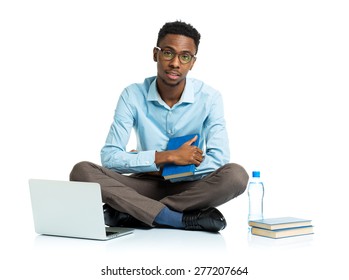 Happy African American College Student With Laptop, Books And Bottle Of Water Sitting On White Background