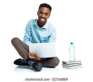 Happy African American College Student With Laptop, Books And Bottle Of Water Sitting On White Background