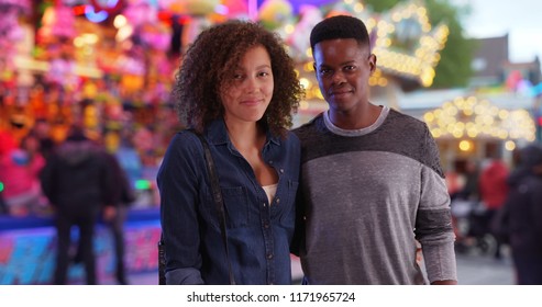 Happy African American Couple At The Carnival Pose For A Portrait