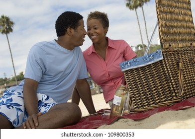 Happy African American Couple Enjoying Picnic On The Beach