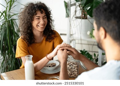 Happy african american couple having breakfast together in the kitchen - Powered by Shutterstock