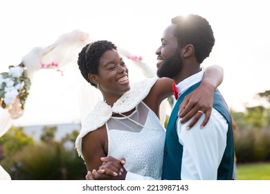 Happy african american couple holding hands during wedding. Wedding day, friendship, inclusivity and lifestyle concept. - Powered by Shutterstock