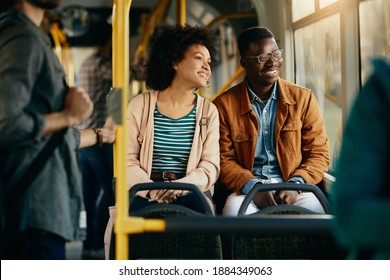 Happy African American couple looking through the window while traveling by bus together.  - Powered by Shutterstock