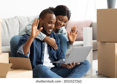 Happy African American Couple Making Video Call With Family Or Friends After Moving To Their Own Apartment, Cheerful Black Spouses Using Laptop Computer, Waving Hands At Web Camera And Smiling