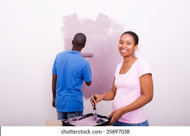 Happy African American Couple Painting New House