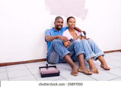 Happy African American Couple Painting New House