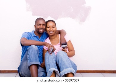 Happy African American Couple Painting New House